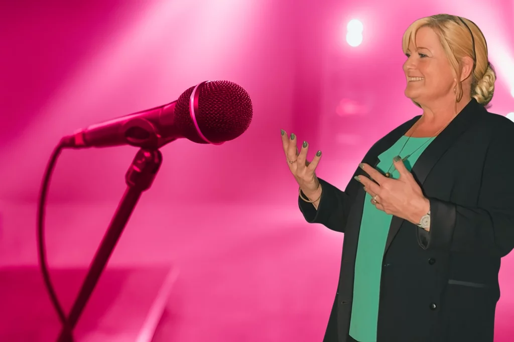 Norah Howie Presenting Her Show In Front of a Microphone